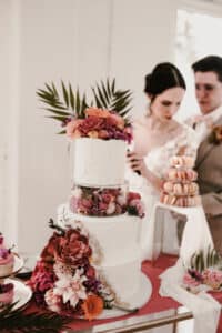 Sweets-Tabel mit Macarons, Cupcakes und Hochzeitstorte